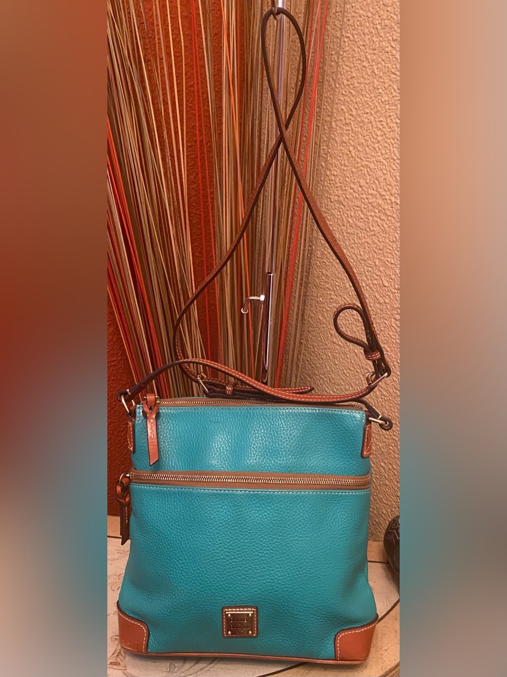 Dooney & Bourke -Pebble Grain Crossbody Bag in a vibrant teal/turquoise colorway